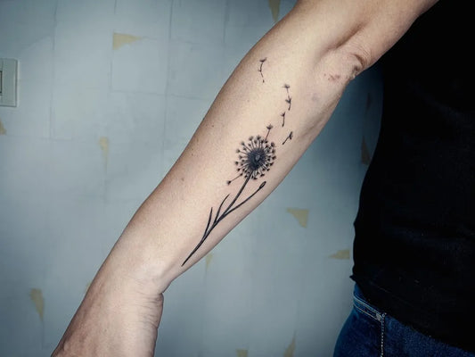 Small Blackwork Dandelion Tattoo on Women Forearm by @ana_faganel_dotline_pmu