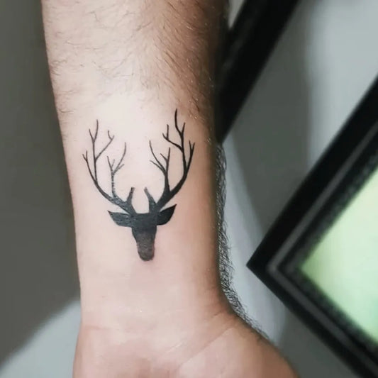 Small Blackwork Deer Head Tattoo on Men Wrist by @hanifekurumlu