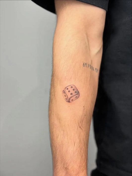 Small Blackwork Dice Tattoo on Men Arm by @yvet.tattoos.art