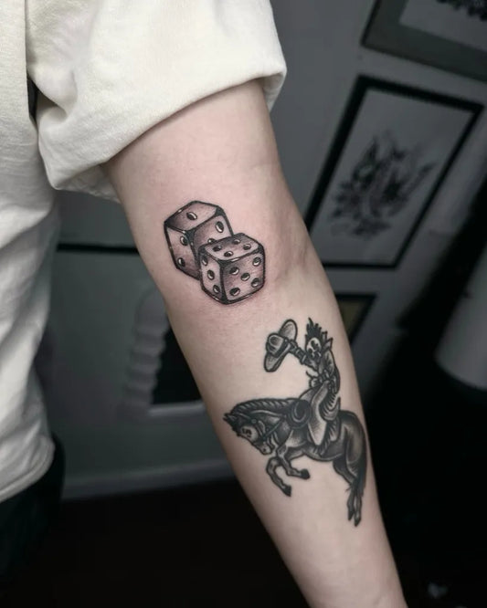 Small Blackwork Dice and Cowboy Tattoo on Women Arm by @erickforemantattoos
