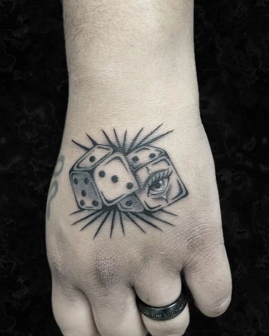 Small Blackwork Dice and Eye Tattoo on Men Wrist by @r.medina.tattoos