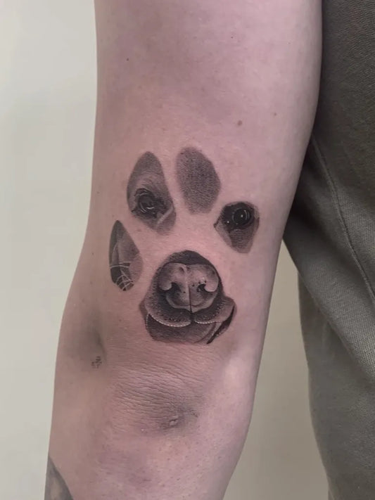 Small Blackwork Dog Paw Face on Men Arm Tattoo by @micro_man_