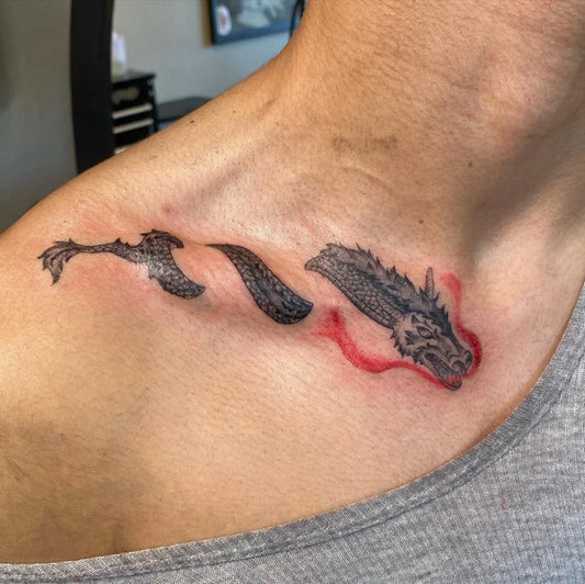 Small Blackwork Dragon Tattoo on Women Collarbone by @nev.inks