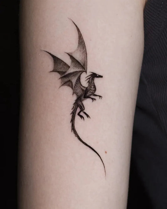 Small Blackwork Dragon on Women Arm Tattoo by @dziedzic.tattoo