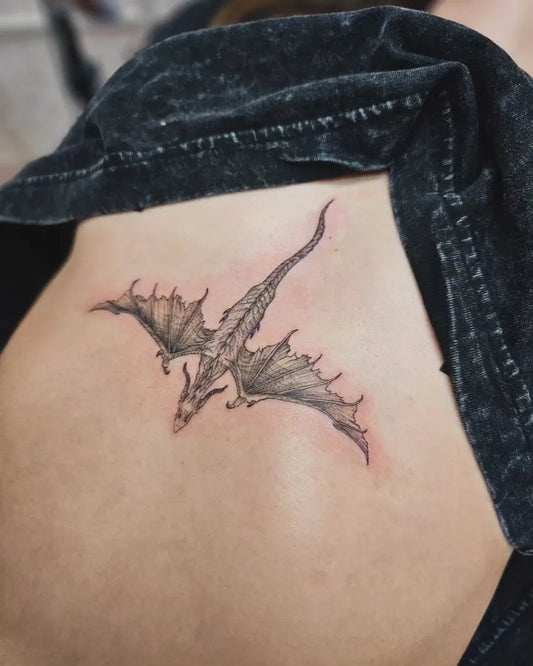 Small Blackwork Dragon on Women Sternum Tattoo by @taylahjadeart
