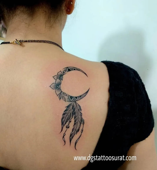 Small Blackwork Dream Catcher with Moon and Flowers Tattoo on Women Shoulder by @karan_dgstattoo