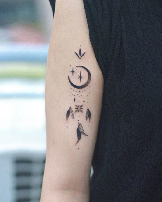 Small Blackwork Dreamcatcher with Moon and Stars Tattoo on Women Arm by @ink_billow
