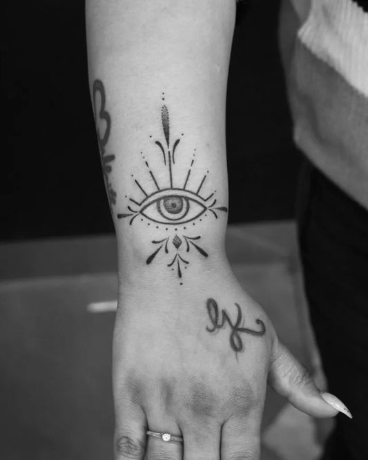 Small Blackwork Evil Eye with Dots on Women Wrist Tattoo by @skinmachinetattoo