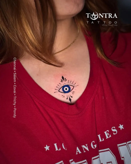Small Blackwork Evil Eye with Leaves on Women Chest Tattoo by @tantra_tattoo_tamilnadu