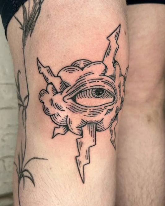 Small Blackwork Eye in Cloud with Lightning Tattoo on Men Knee by @halfbackwards