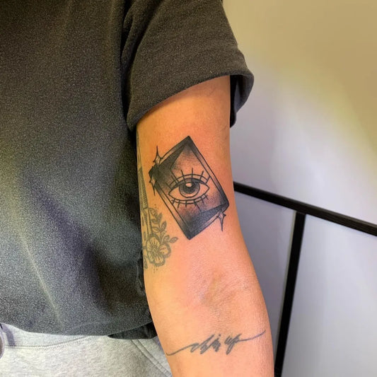 Small Blackwork Eye in Diamond Tattoo on Women Bicep by @ingrid_elaine