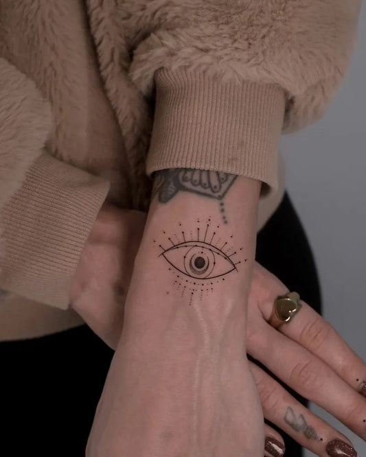 Small Blackwork Eye on Women Wrist Tattoo by @monochrom.ink