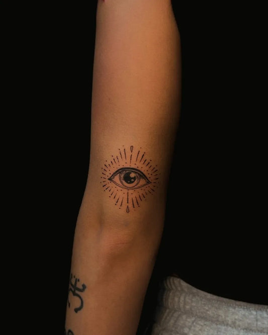 Small Blackwork Eye with Rays on Women Arm Tattoo by @tat2_oren
