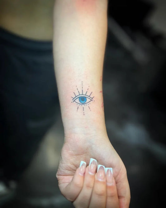 Small Blackwork Eye with Rays on Women Wrist Tattoo by @makoy_tattoo