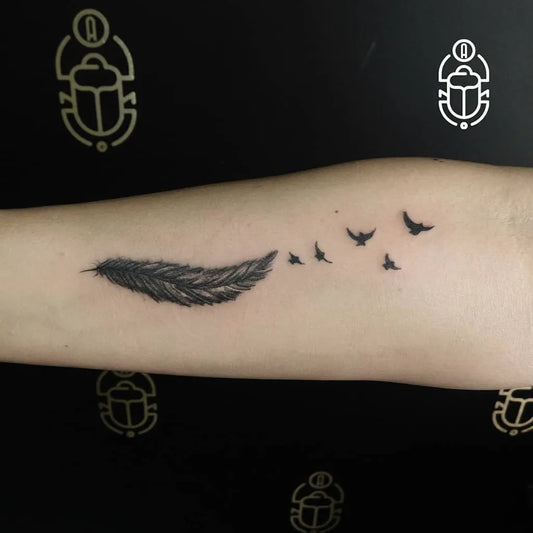 Small Blackwork Feather and Birds Tattoo on Women Forearm by @oscarandres.tattoo