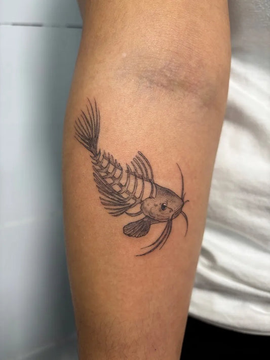 Small Blackwork Fish Tattoo on Men Forearm by @stabby.angel
