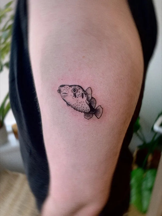 Small Blackwork Fish Tattoo on Men Upper Arm by @pansyink_tattoos