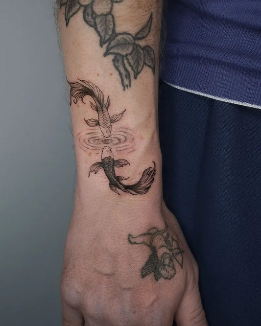 Small Blackwork Fish Tattoo on Men Wrist by @libertyjtattoo