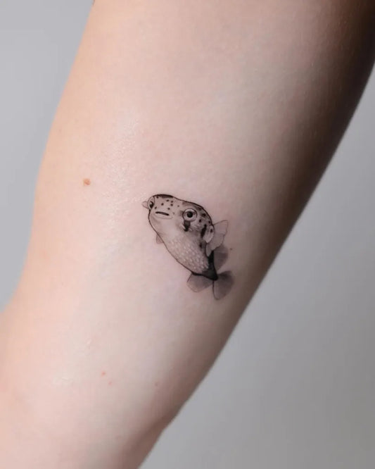 Small Blackwork Fish Tattoo on Women Arm by @aquarium._.studio