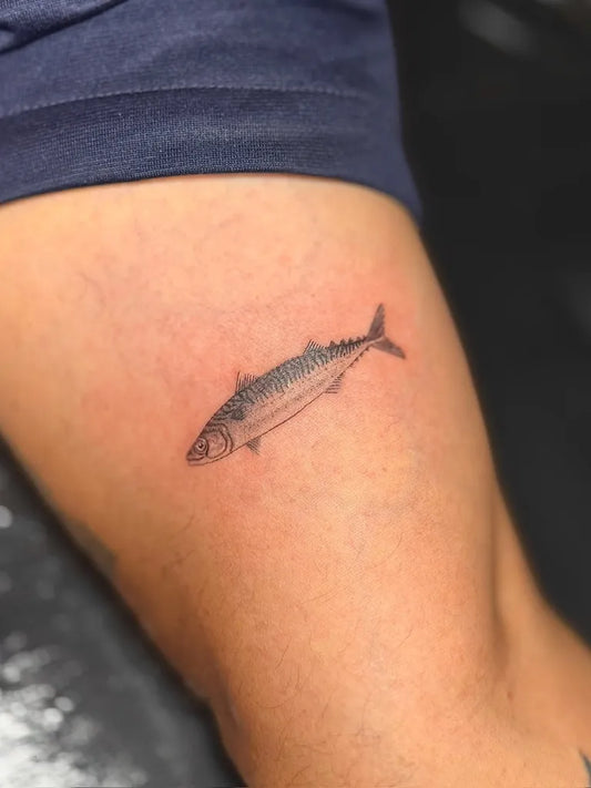 Small Blackwork Fish Tattoo on Women Thigh by @soullectiveink
