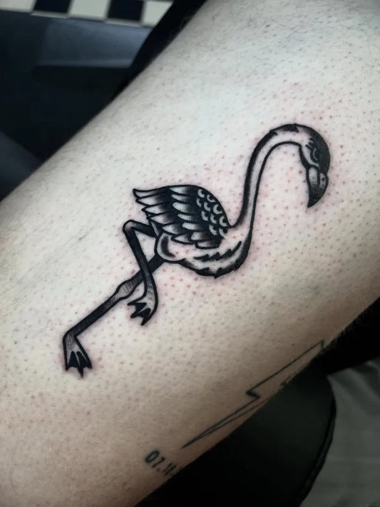 Small Blackwork Flamingo Tattoo on Women Thigh by @skeletoncatdesigns