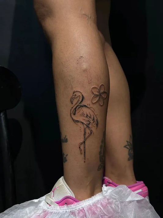 Small Blackwork Flamingo and Flowers Tattoo on Women Leg by @hex__tattoo