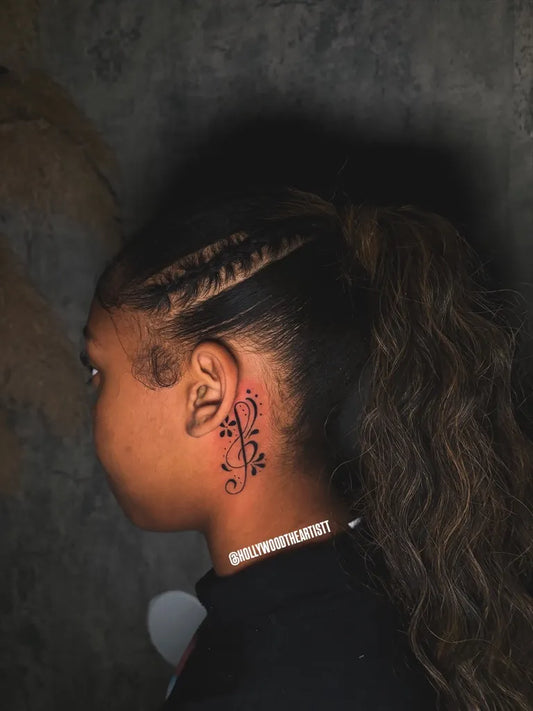 Small Blackwork Floral Tattoo on Women Behind the Ear by @hollywoodtheartistt
