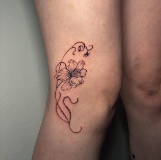 Small Blackwork Flower Tattoo on Women Knee by @liz.tattooz