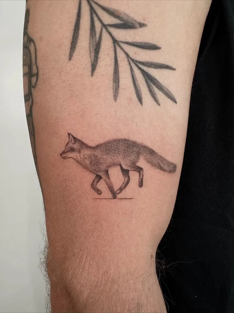 Small Blackwork Fox Tattoo on Men Arm by @louka.tattooist