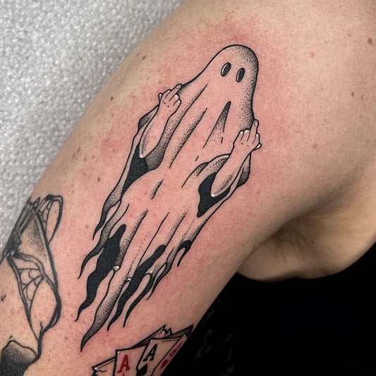 Small Blackwork Ghost Tattoo on Men Upper Arm by @nancychapmantattoos