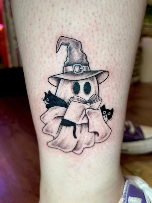 Small Blackwork Ghost with Cats and Book Tattoo on Women Leg by @tattoosbyjamma