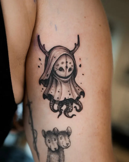 Small Blackwork Ghost with Tentacles and Llamas Tattoo on Women Upper Arm by @apso_tattoo