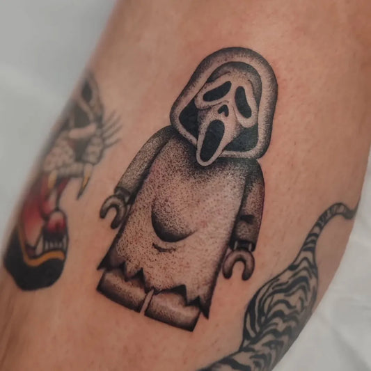Small Blackwork Ghostface Lego Horror Tattoo on Men Arm by @rileystronachtattoo