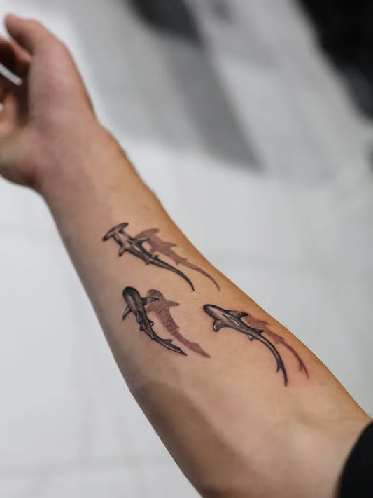 Small Blackwork Hammerhead Sharks on Men Arm Tattoo by @sudiptattoos