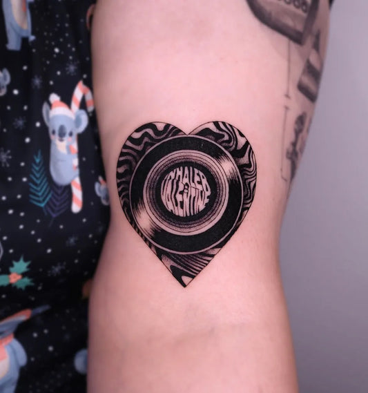 Small Blackwork Heart VinylRecord Music Tattoo on Women Arm by @kashatattooer