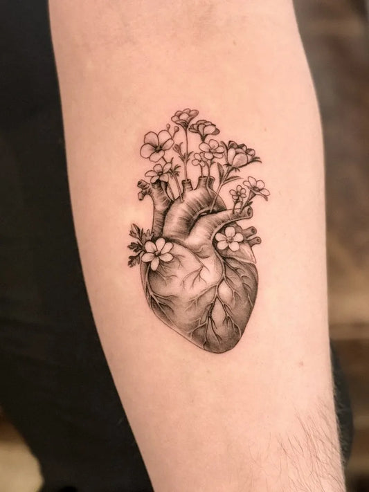 Small Blackwork Heart and Flowers on Men Arm Tattoo by @selma.tattoo