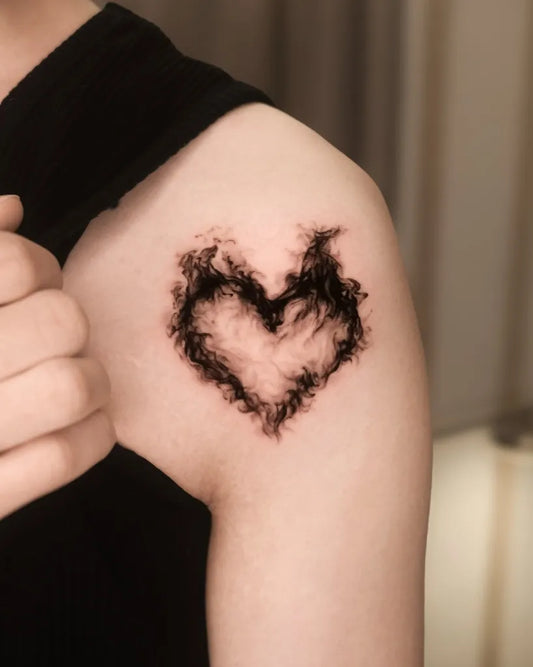 Small Blackwork Heart on Women Shoulder Tattoo by @haeo_tattoo