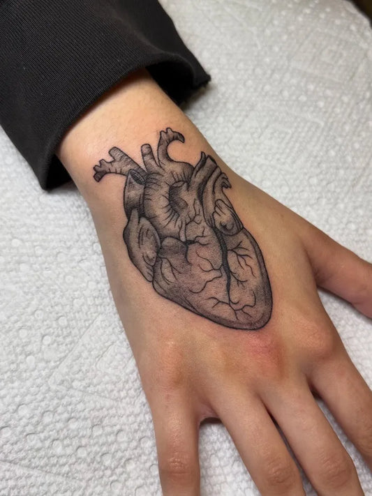 Small Blackwork Heart on Women Wrist Tattoo by @ashole.inkz