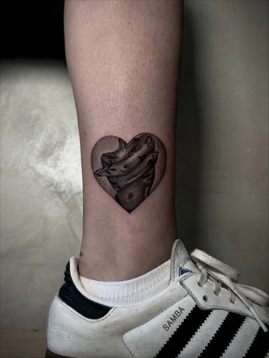 Small Blackwork Heart with Face on Women Leg Tattoo by @vien_ttt