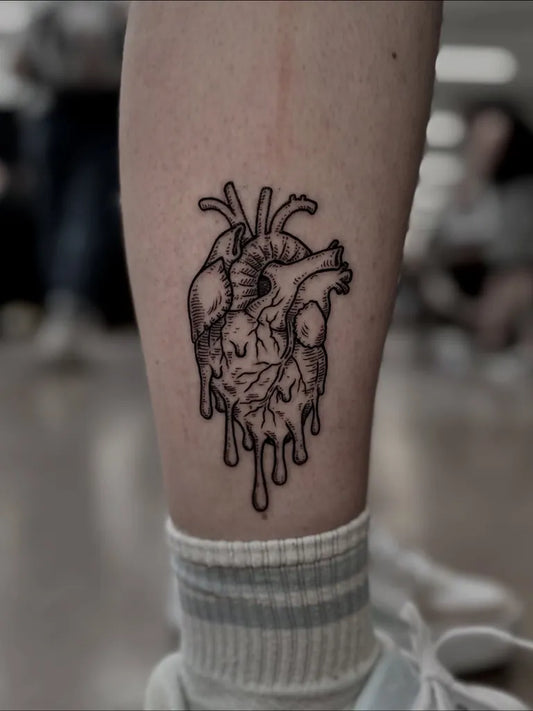 Small Blackwork Heart with Melting Drips on Women Leg Tattoo by @doctor_sunda