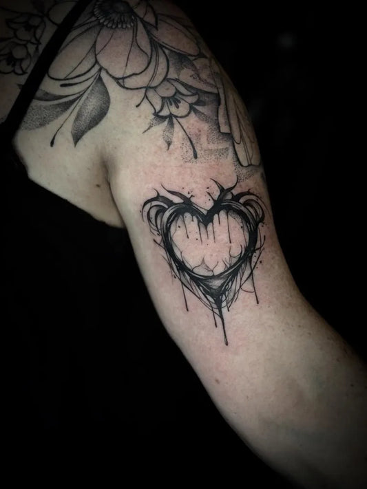 Small Blackwork Heart with Thorns on Women Arm Tattoo by @rheakimtattoo