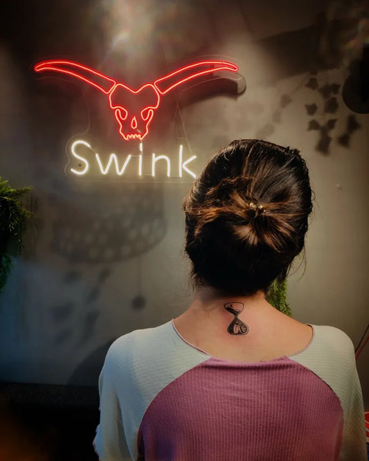 Small Blackwork Hourglass Tattoo on Women Nape by @swink_tattoo_studio