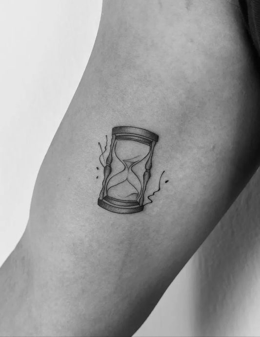 Small Blackwork Hourglass and Sand Tattoo on Women Arm by @tatminntoo