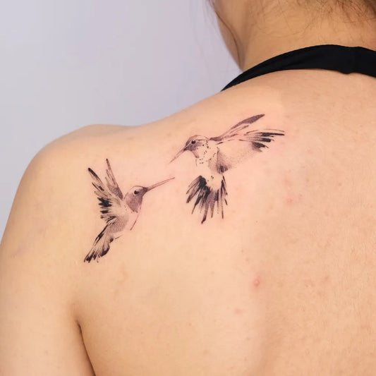 Small Blackwork Hummingbirds on Women Shoulder Tattoo by @maobi.tattoo