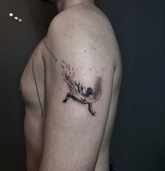 Small Blackwork Icarus with Wings and Falling Feathers on Men Arm Tattoo by @6moonstattoostudio