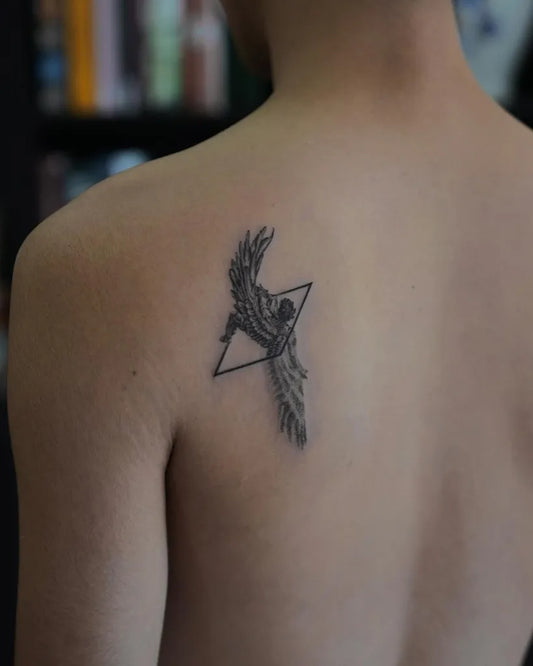Small Blackwork Icarus with Wings on Men Shoulder Tattoo by @inkwithlemon