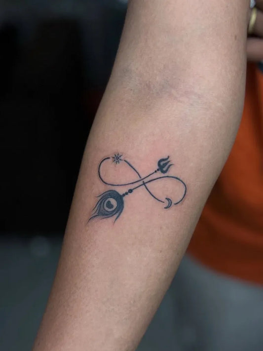 Small Blackwork Infinity Trishul Peacock Tattoo on Women Forearm by @kabirainktattooandpiercing