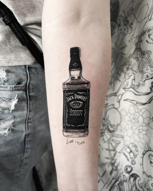Small Blackwork JackDanielsBottle on Women Arm Tattoo by @jake_scrivner