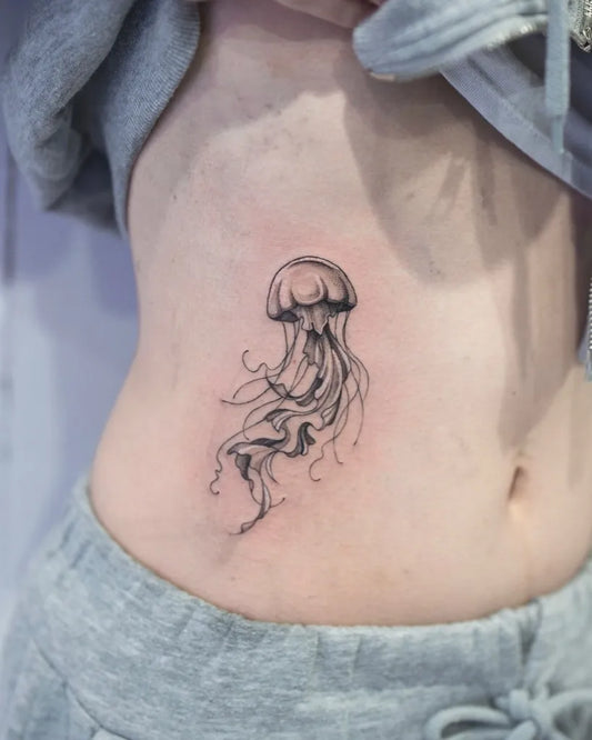 Small Blackwork Jellyfish Tattoo on Women Side by @tattoo_studio_shinjuku