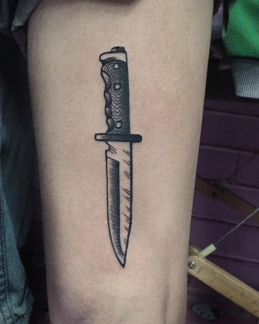 Small Blackwork Knife Tattoo on Men Thigh by @blacktee.lucky